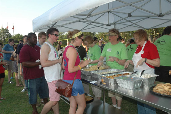 Teach For America participants line up as volunteers serve the catfish during “Catfish on the Quad” activities at Delta State.